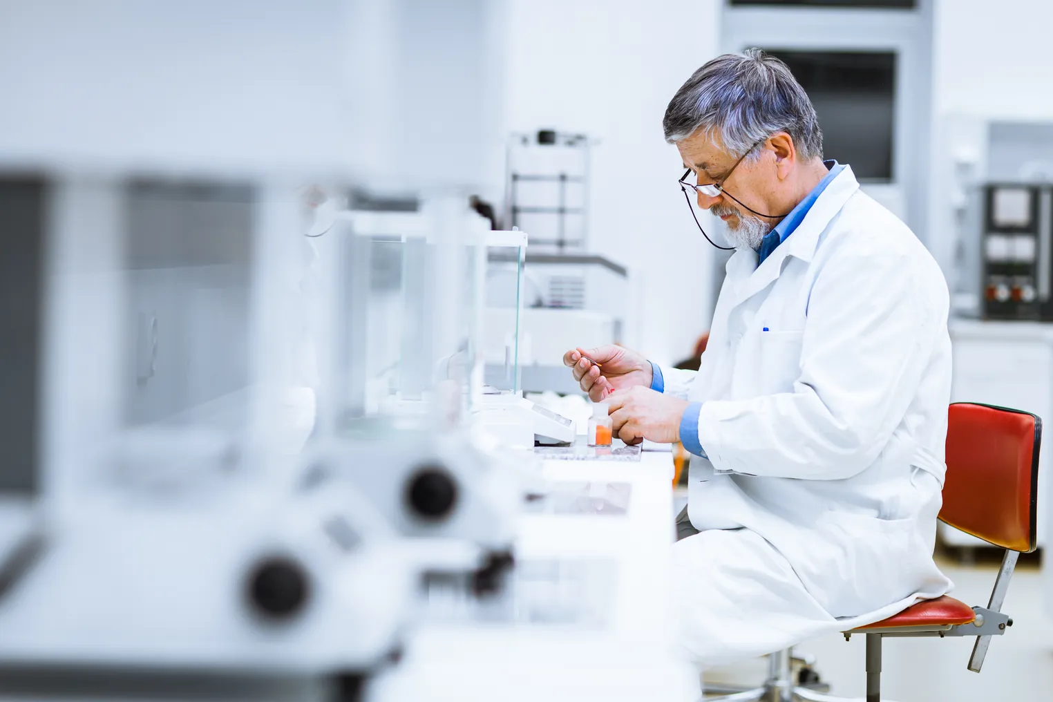 Senior researcher carrying out scientific research in a lab