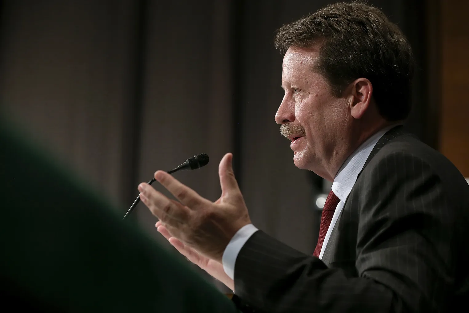 Dr. Robert Califf, FDA commissioner, speaking at a podium with hands up