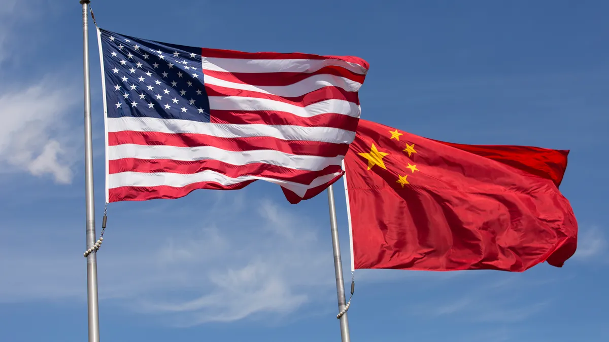 Symbolic of Sino-American relations, the flag of the United States of America and the flag of the Republic of China fly together on flag poles next to each other on a sunny, windy day.