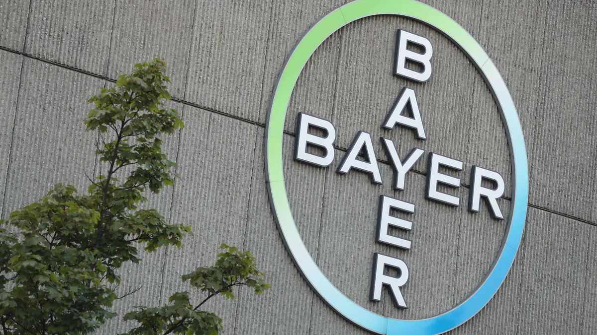The logo of German pharmaceuticals and chemicals giant Bayer stands over Bayer corporate offices on September 14, 2016 in Berlin, Germany.