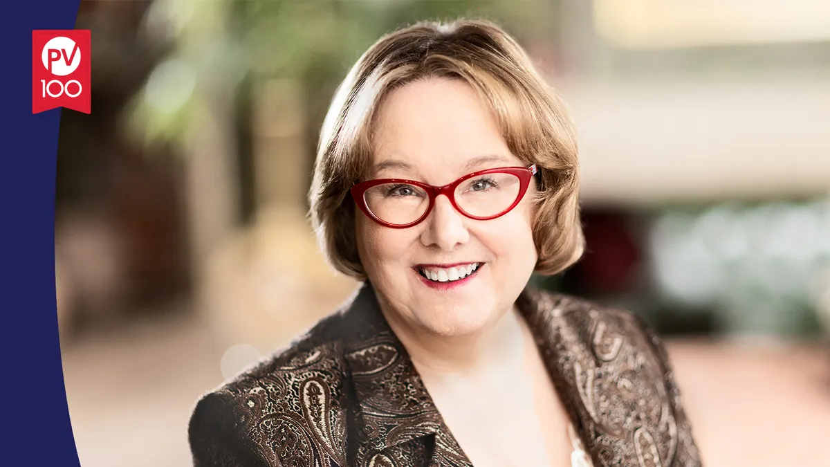 A portrait of Maureen Hennessey framed with a banner icon that reads "PV 100"