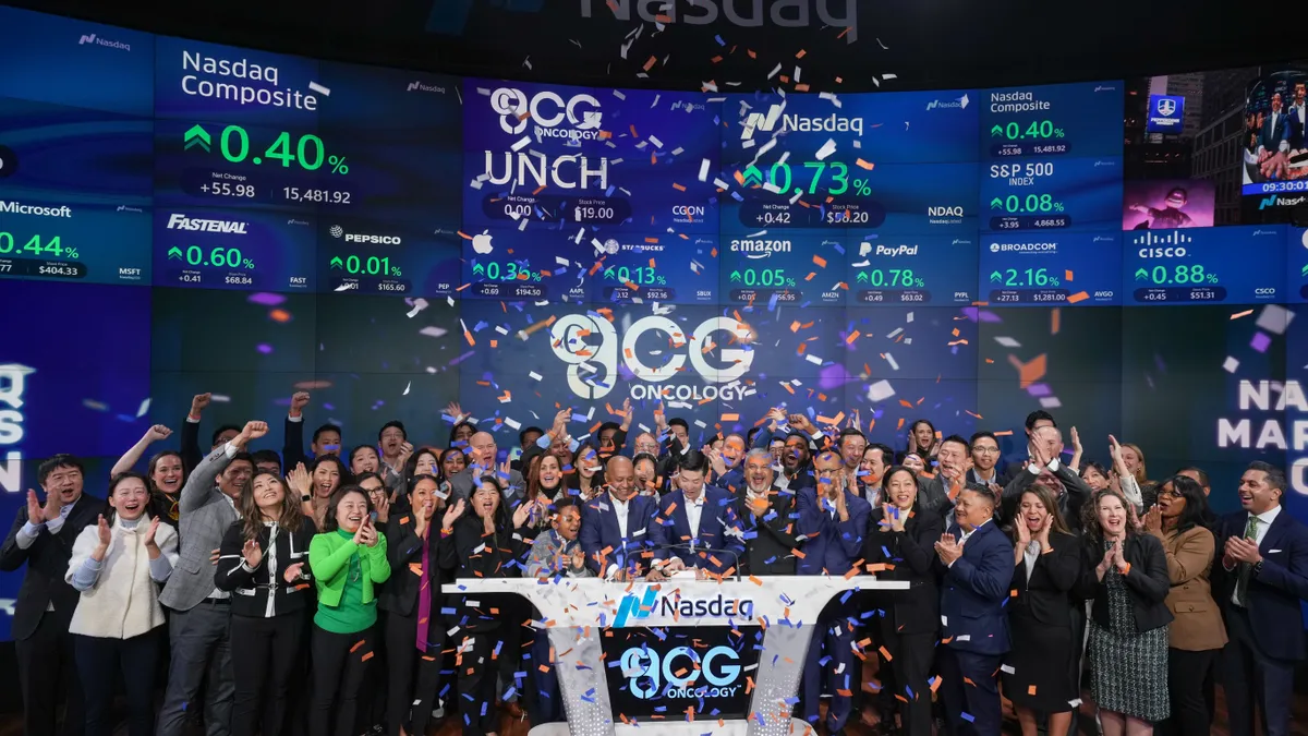 The staff of CG Oncology rings the opening bell at Nasdaq as confetti falls.